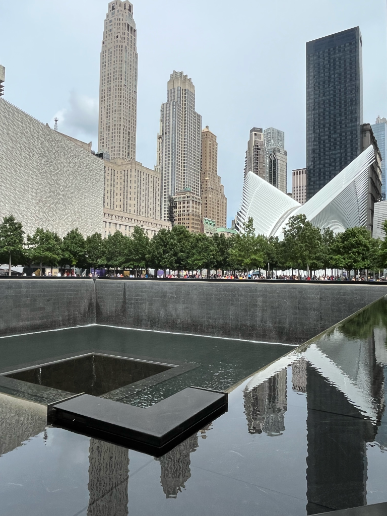9/11 Memorial reflecting pool with NYC skyline and Oculus