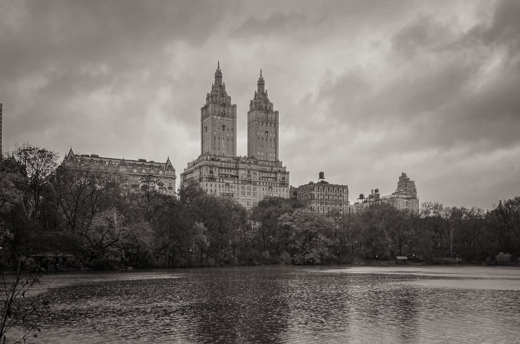 Central Park lake with San Remo towers in black and white, New York City