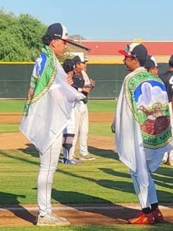 Xander and Sir Prince Mcvay holding Muscogee Creek Nation flags at the Babe Ruth World Series opening ceremonies