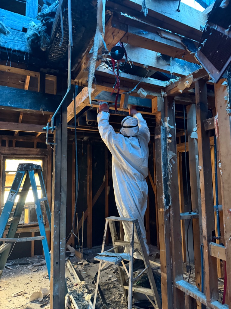 Fire damage abatement — certified technician in full PPE