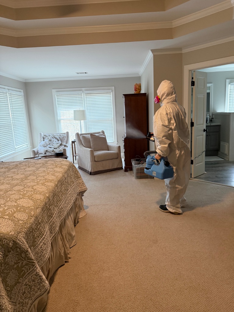 Certified technician treating bedroom for mold