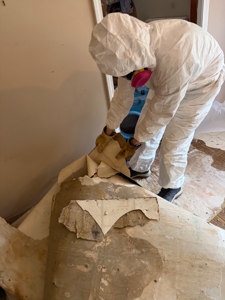 Asbestos floor tile removal — hazmat suit and respirator