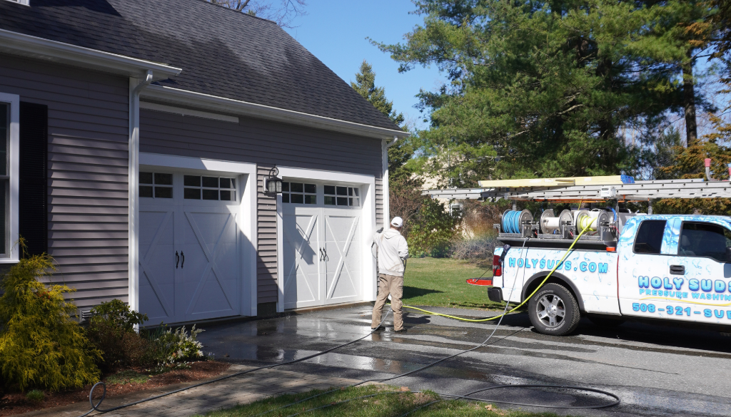 Professional house washing service cleaning home exterior with soft wash method