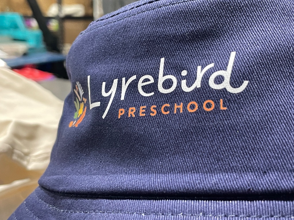 Custom embroidered cap with Lyrebird Preschool logo by Shoalhaven Uniforms