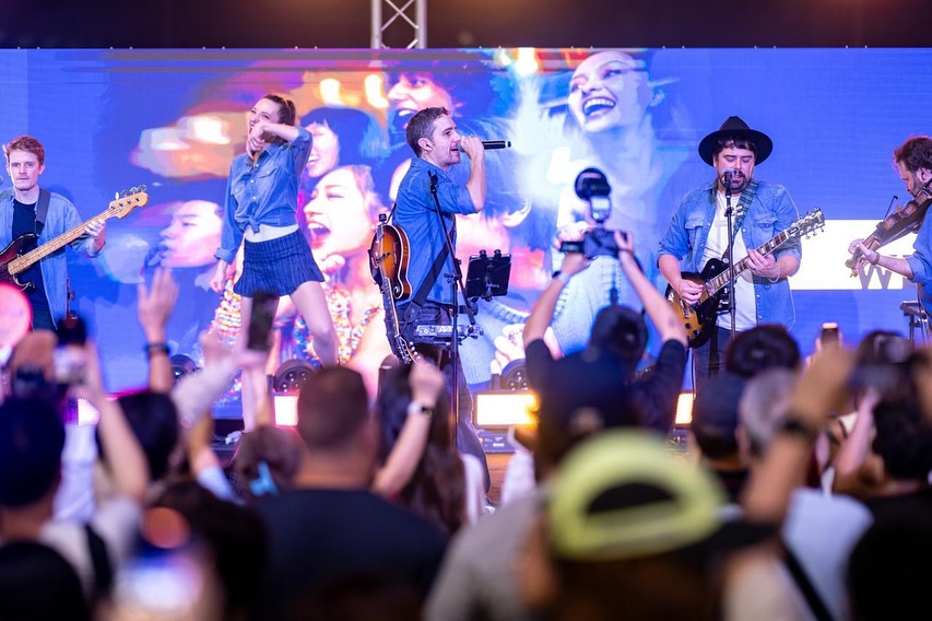 Live performance on stage with dancers and professional lighting