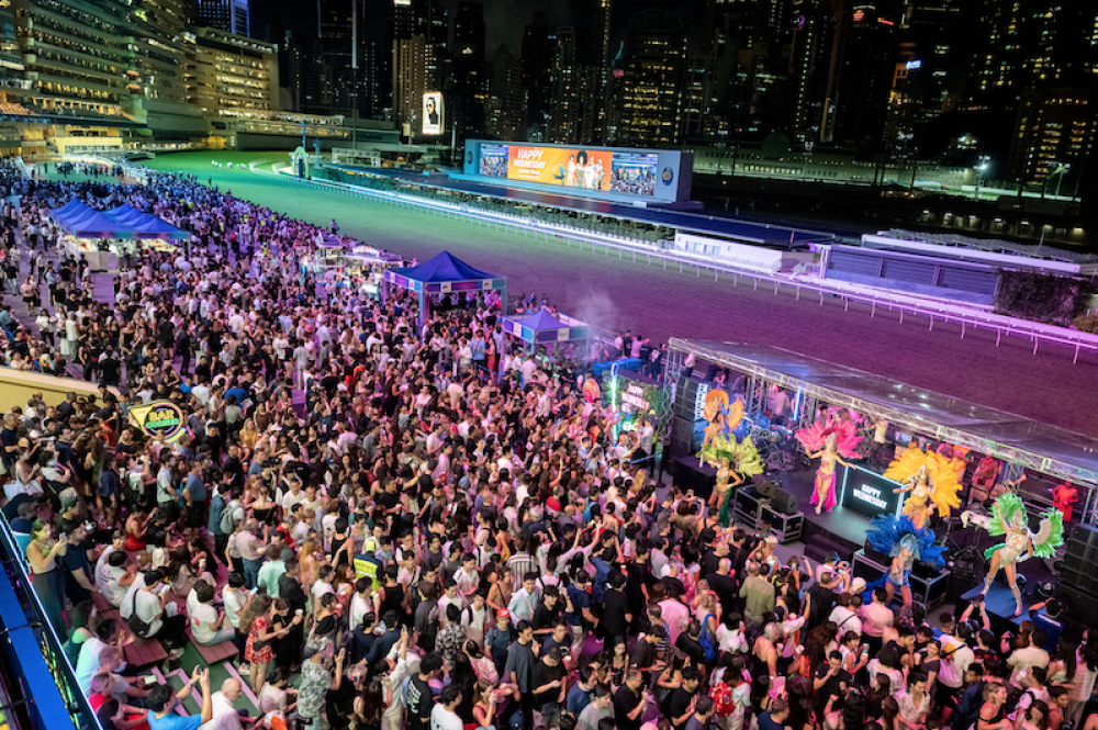 Aerial view of the packed venue with stage and entertainment setup