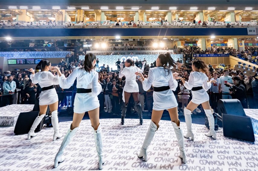 Dancers performing in synchronized choreography for thousands of spectators