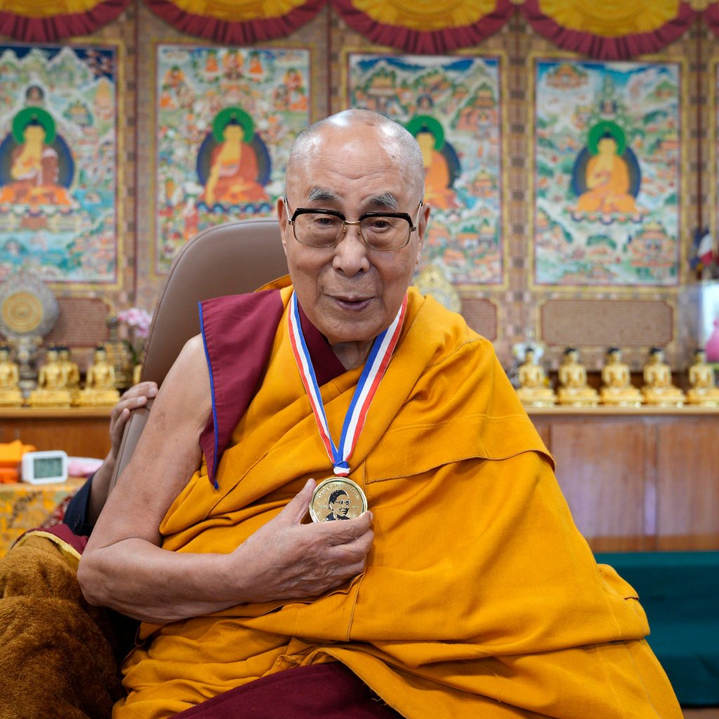 His Holiness the Dalai Lama holding medal