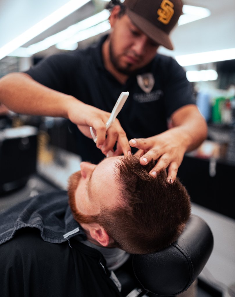 Galindo's barber consulting with client