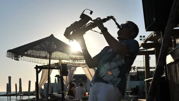 DJ and Saxophonist performing