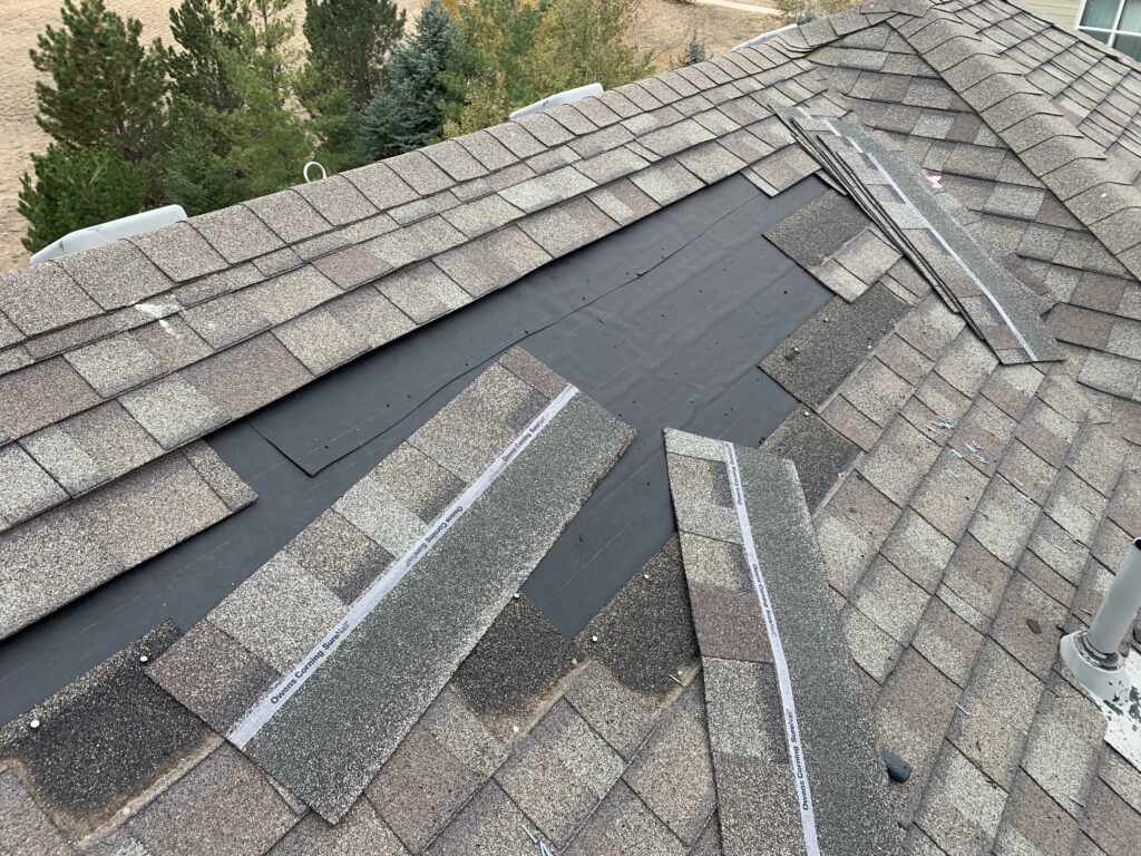 Wind-blown shingles missing from roof