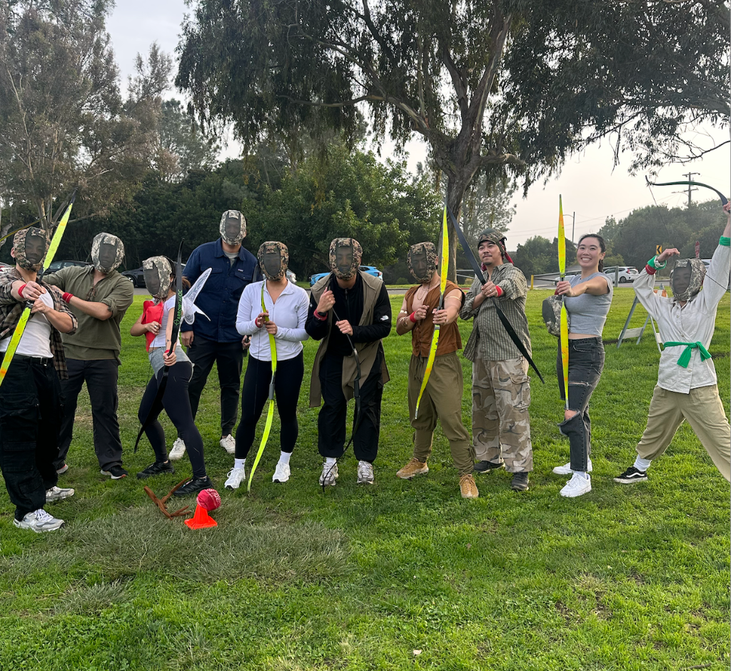 Archery tag rental California - group wearing protective masks playing archery tag games at outdoor park