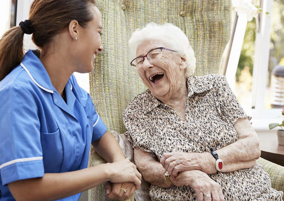 Nurse supporting senior woman