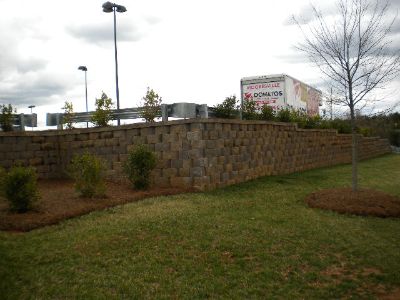 Commercial retaining wall with professional landscaping and planted beds
