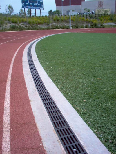 Track and field facility with synthetic turf infield and bleachers