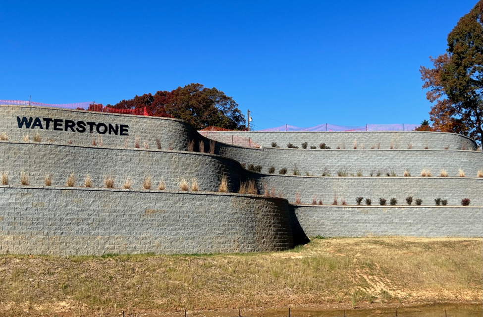 Waterstone commercial retaining wall close-up showing stone texture and plantings