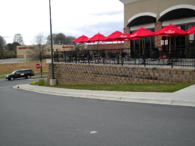 Commercial retaining wall at restaurant entrance with stone veneer finish