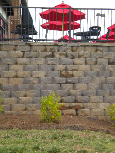 Close-up detail of segmental block retaining wall texture and construction quality