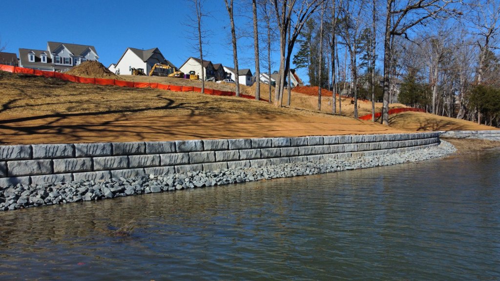 Ground-level view of residential retaining wall along lake shoreline