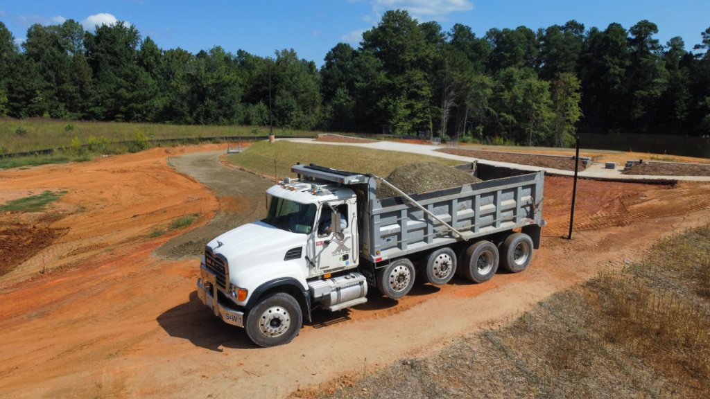Commercial site development with dump truck and earthwork grading operations