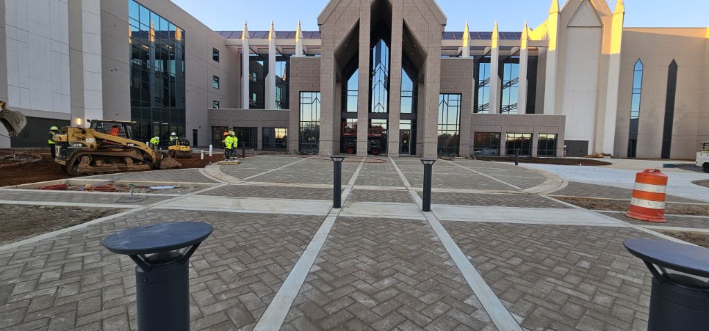 Commercial paver plaza with seating area at building entrance and main entry