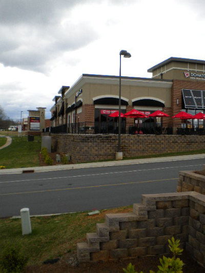 Commercial retaining wall and sitework along street with curb and gutter