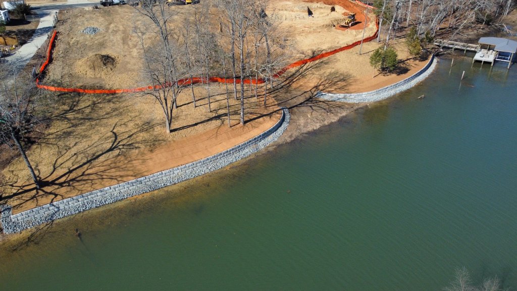 Wide aerial view of completed lakefront retaining wall and shoreline stabilization project