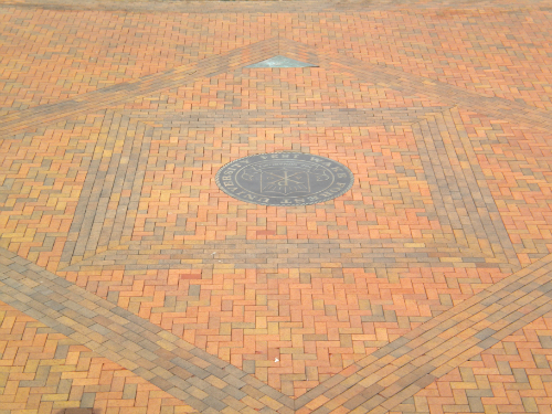 Brick paver plaza with decorative accent banding and multi-color pattern design