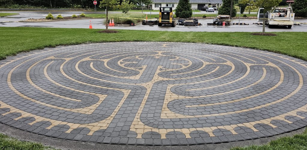 Commercial paver garden with decorative fountain and landscaping installation
