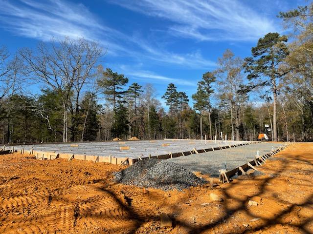 Substation concrete foundation prep showing gravel pad and reinforcement layout