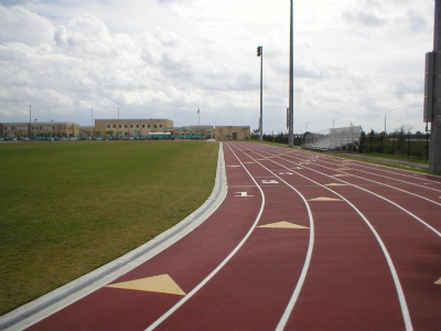 DRAW Enterprises track and field athletic facility construction with trench drain system