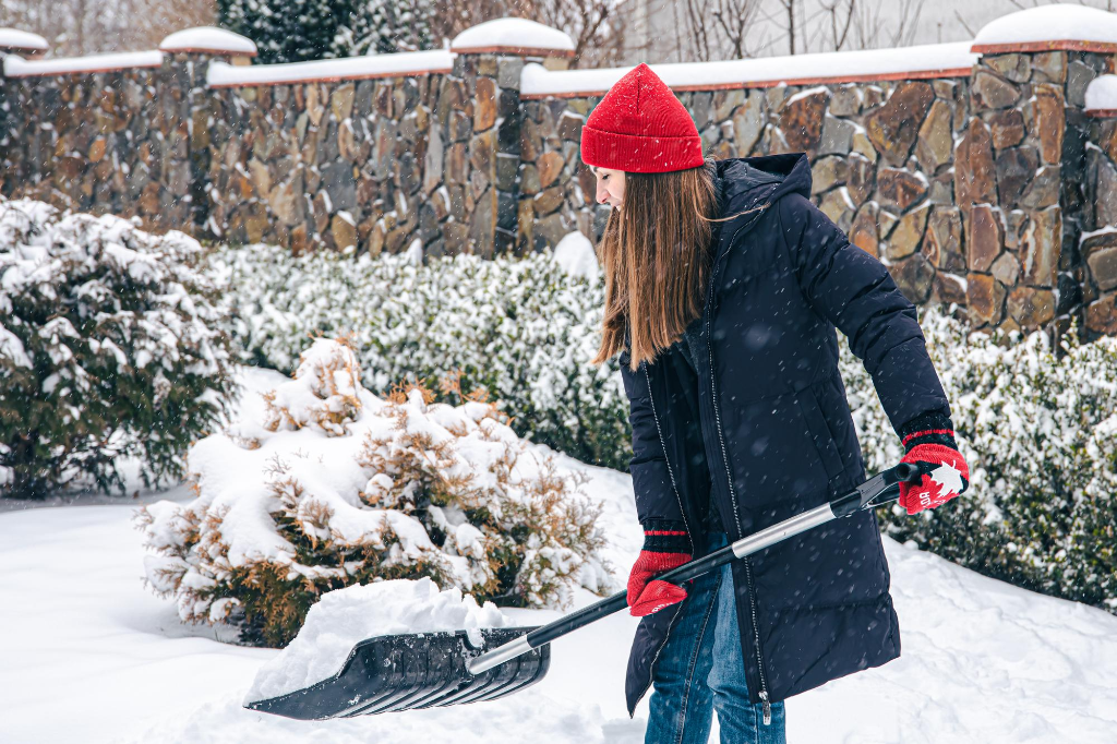 Woman shoveling snow in winter