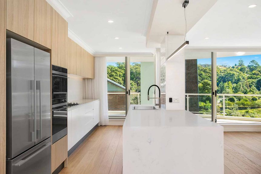 Apartment kitchen renovation with smart stone Carrara benchtops and modern cabinetry in Melbourne