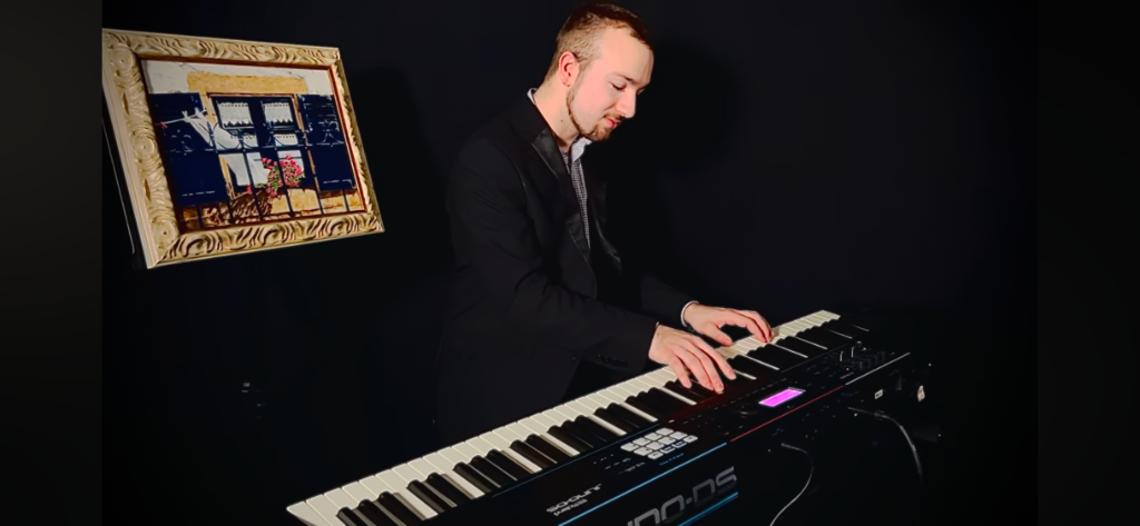 Dawson playing keyboard on stage
