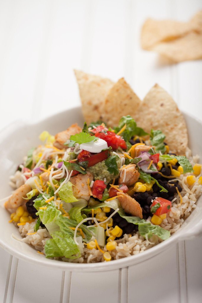 Chipotle burrito bowl with rice, chicken, black beans, guacamole and salsa