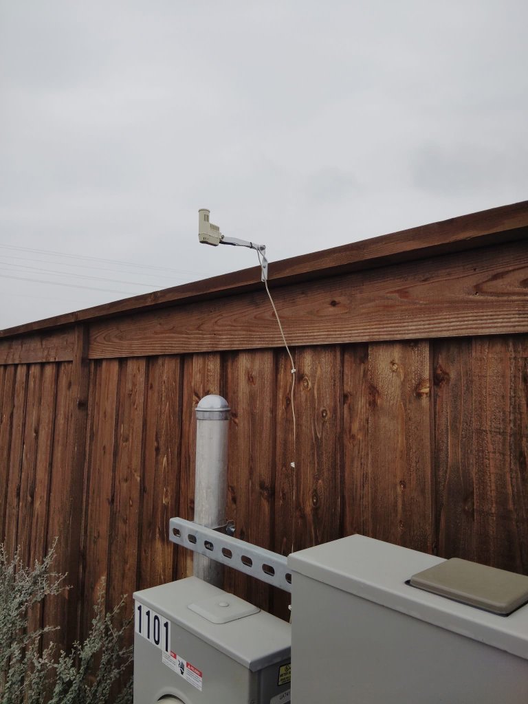 Rain sensor mounted on fence for accurate rainfall detection