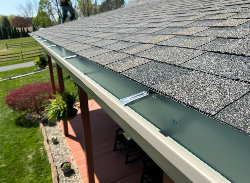 Close-up of shingles and gutter at a roof edge