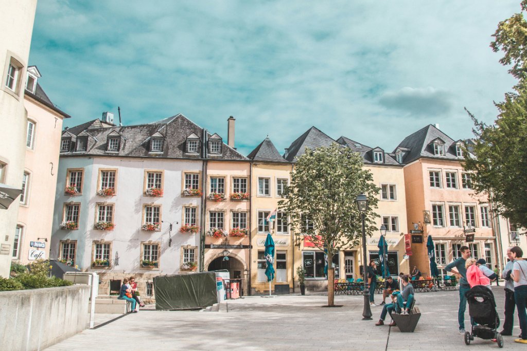 Luxembourg city square with colorful buildings and people