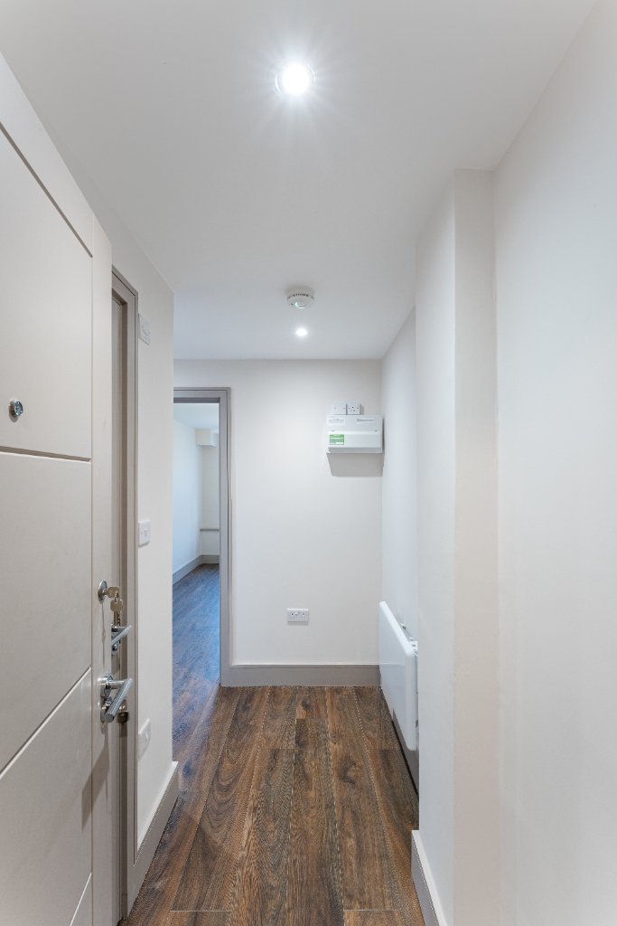 Bathroom detail showing quality fixtures and wood-effect tiles