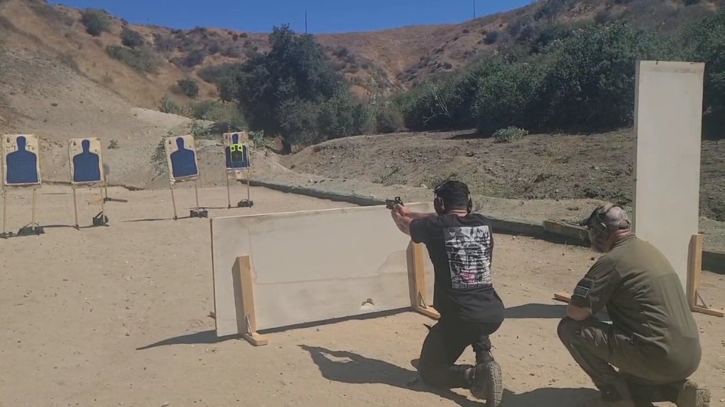 Defensive pistol shooting with instructor guidance