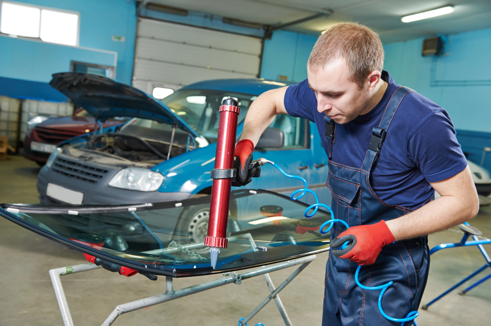 Auto glass repair technician working