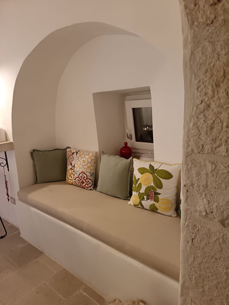 Arched stone nook with decorative pillows