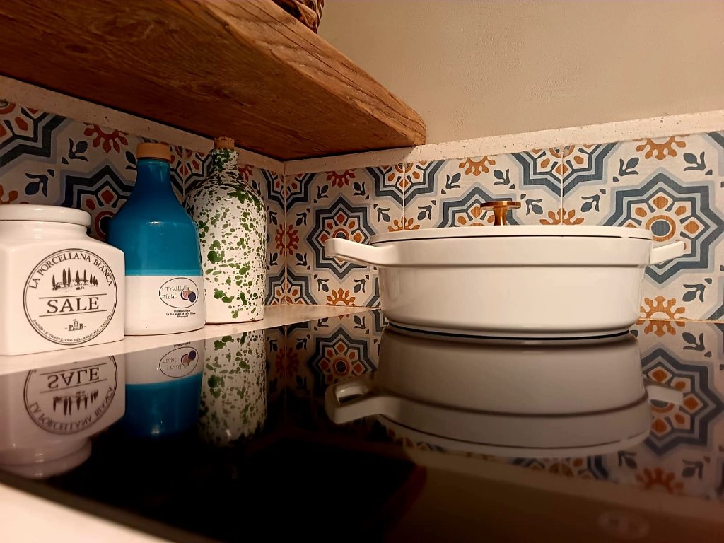 Kitchen shelf with ceramic cookware and decor