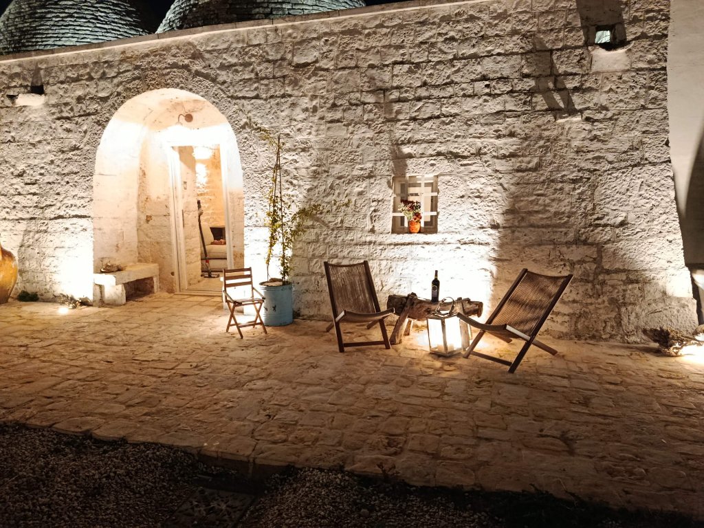 Evening courtyard with archway and lounge chairs