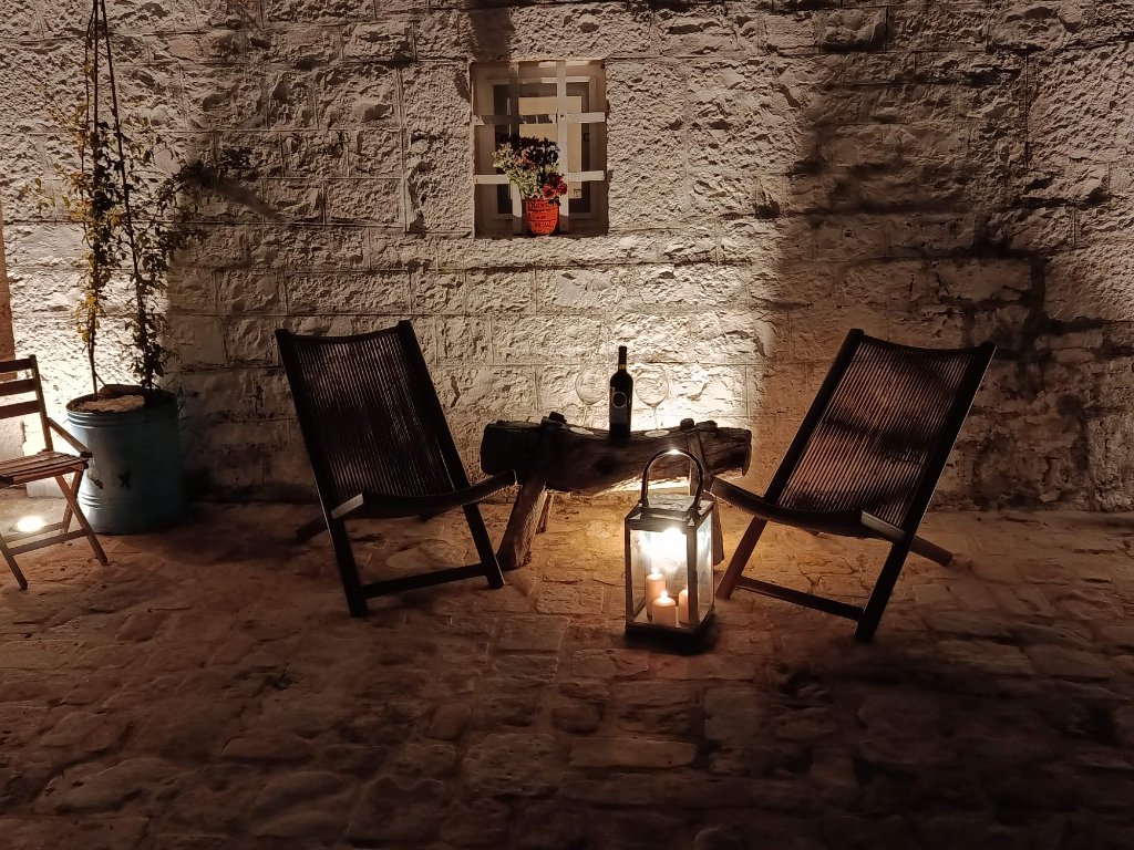 Intimate courtyard seating with candlelit lantern