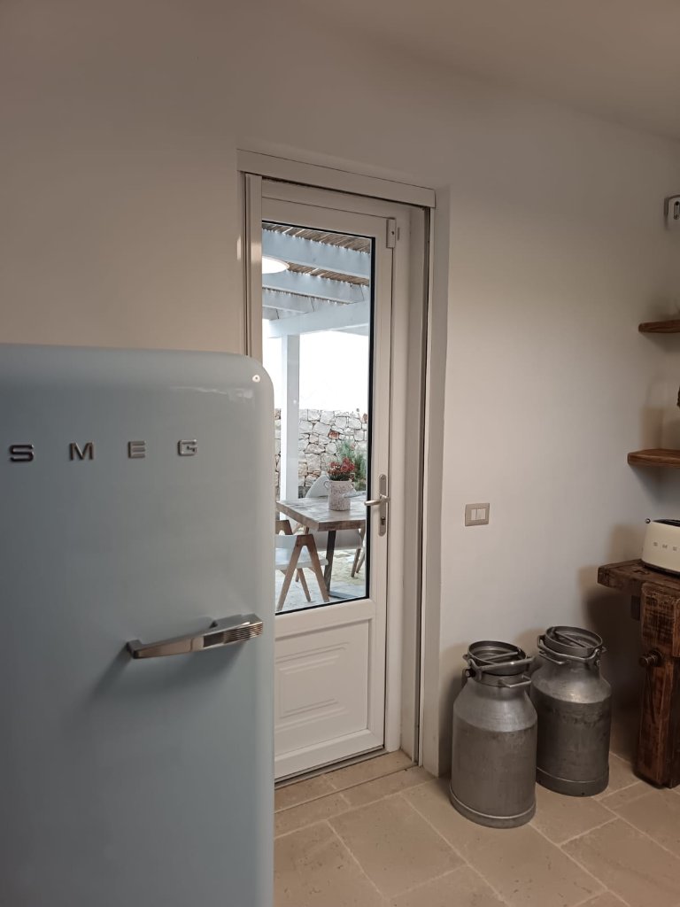 Indoor kitchen connecting to outdoor dining area