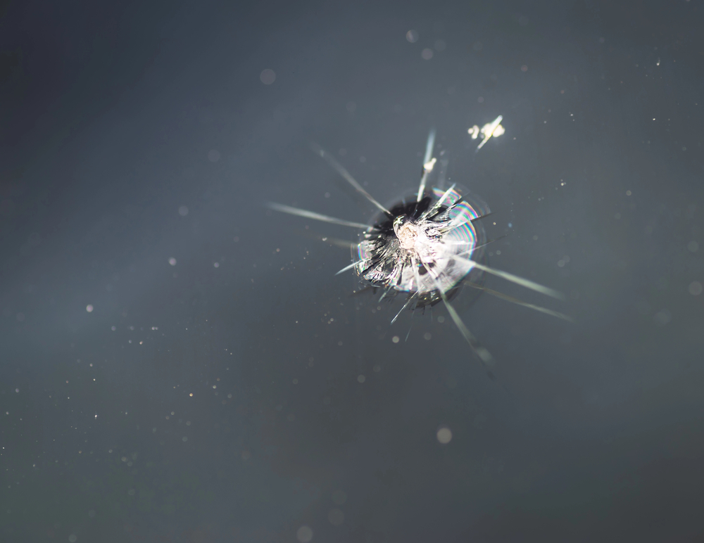 Windshield chip damage Dallas - Close-up of windshield glass chip requiring repair service