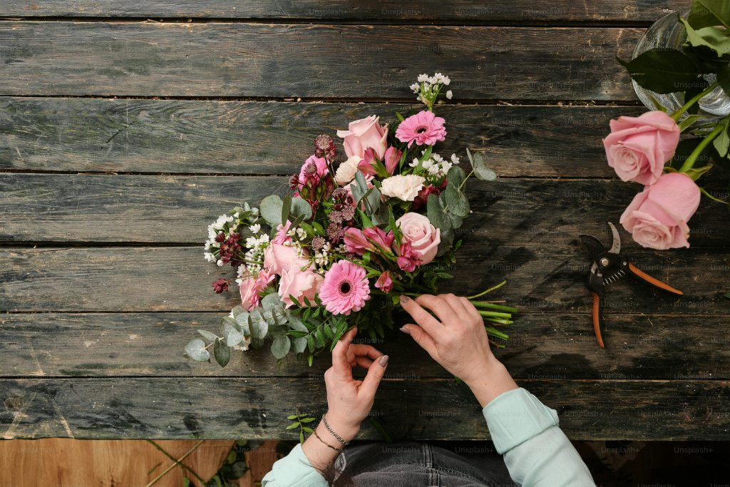 Beverly Hills Flower Company florist arranging luxury flowers — contact our Beverly Hills boutique at 8383 Wilshire Blvd