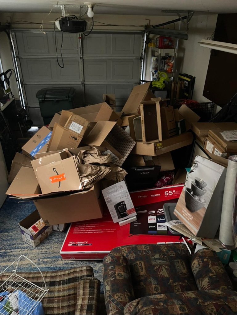 Before garage cleanout - cluttered garage with boxes and storage items