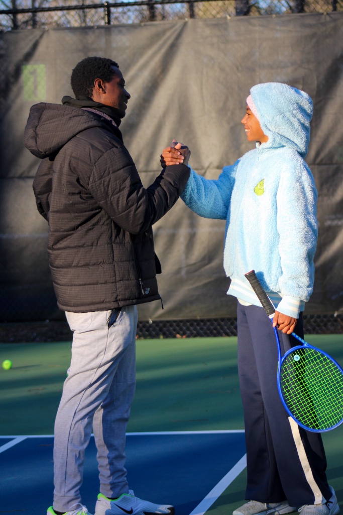 Coach Tee working one-on-one with a junior tennis player during a private tennis lesson in Roswell, GA